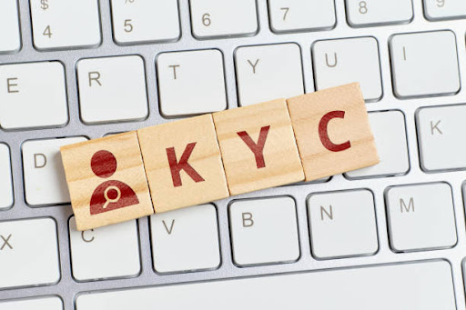 Lettering KYC with abstract persona on keyboard.